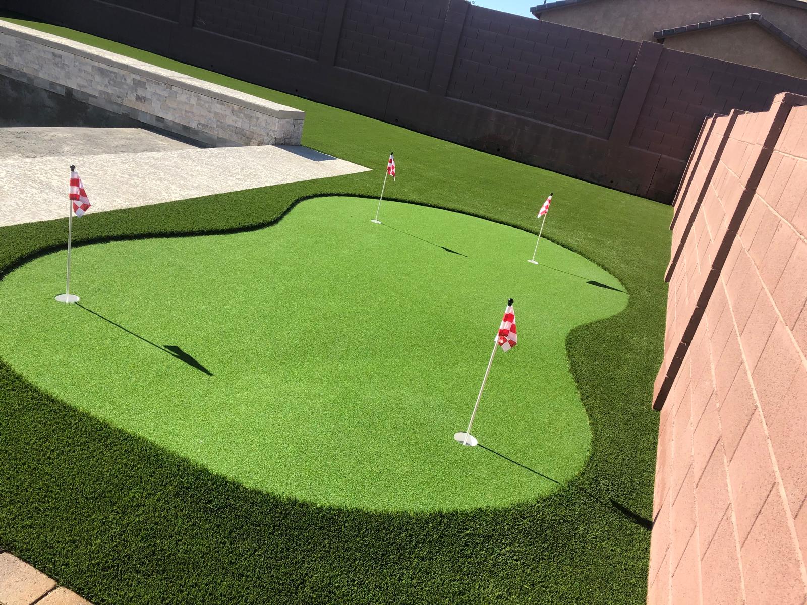 Custom artificial grass putting green with flags installed in Phoenix Arizona