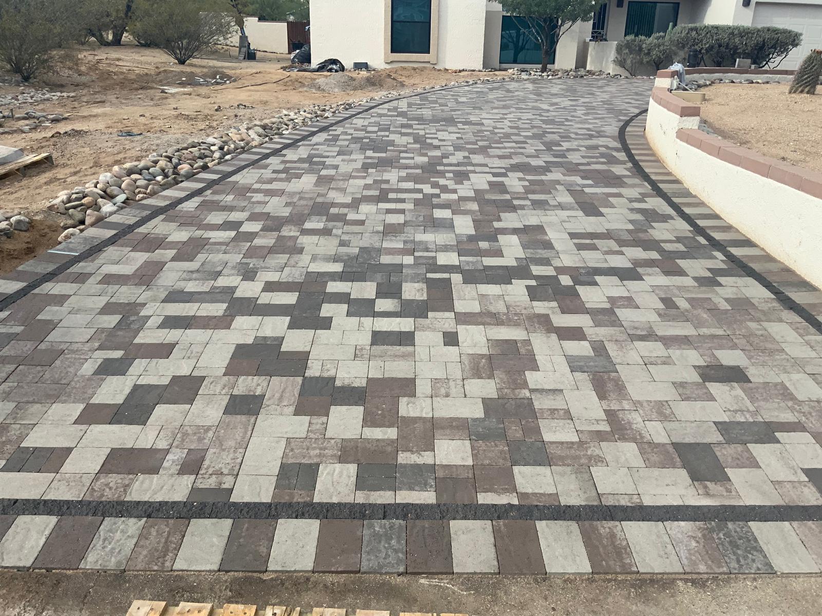 Close-up of multi-tone paver driveway with dark accent border in Phoenix Arizona