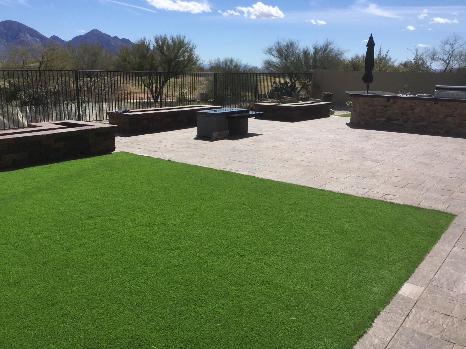 Artificial grass lawn beside an outdoor kitchen patio in a Phoenix Arizona backyard