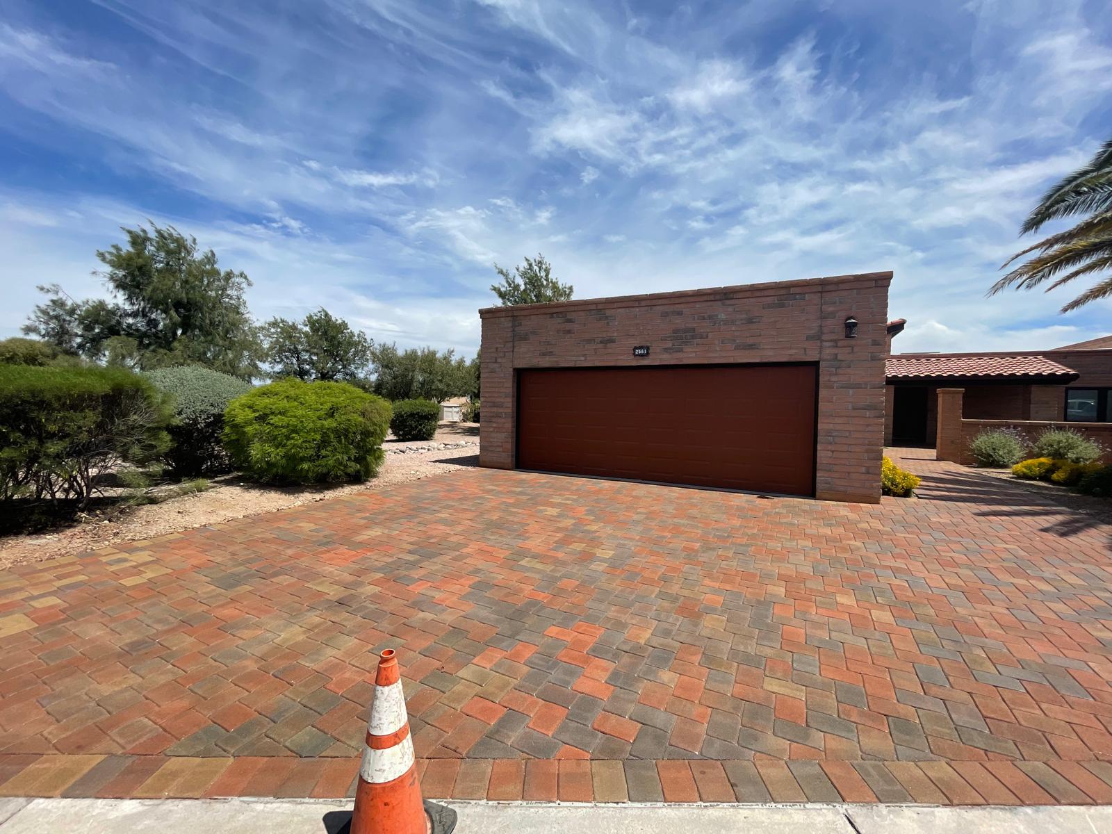 Red and tan brick paver driveway in front of a brick garage in Phoenix Arizona