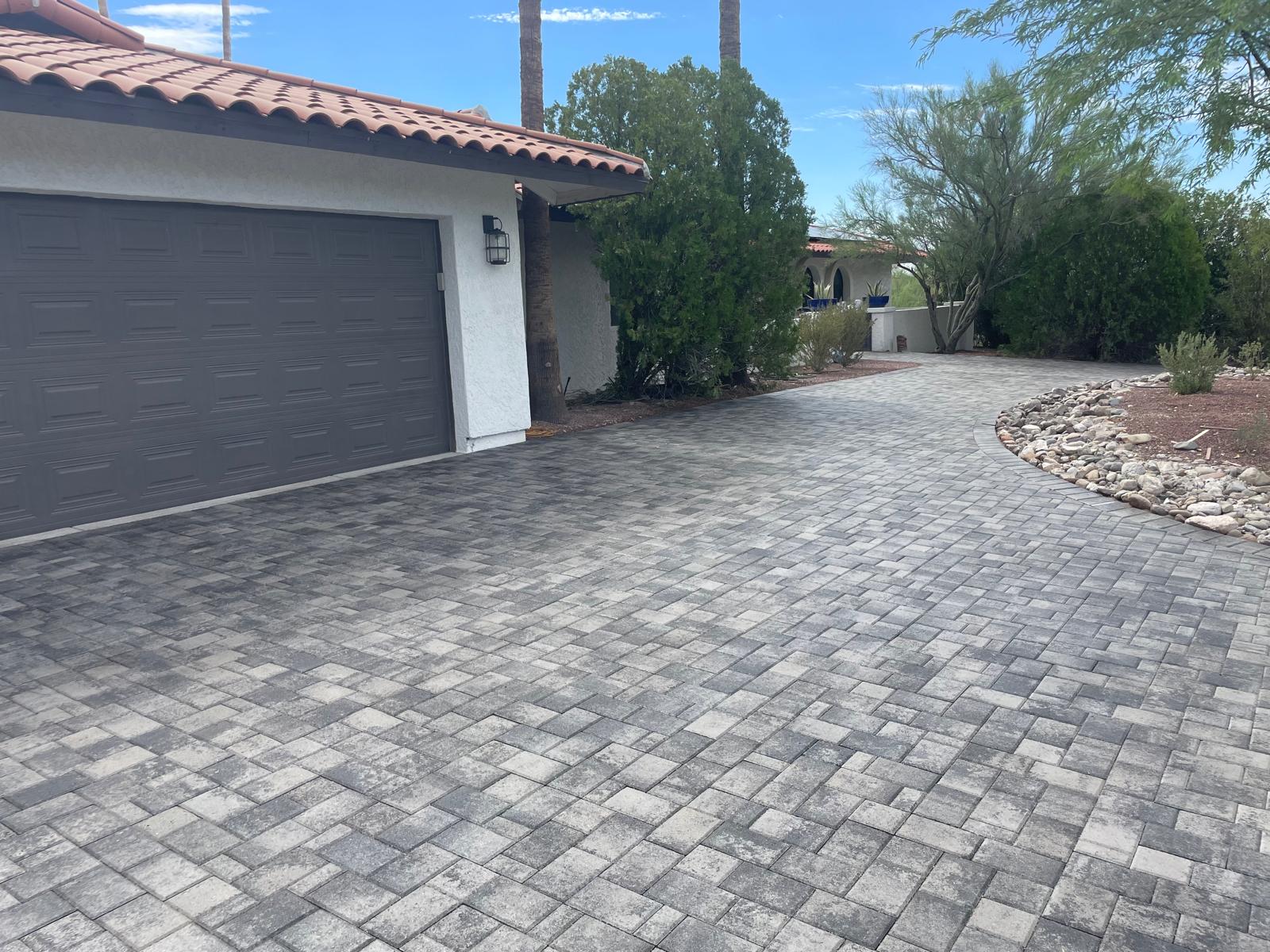 Gray cobble paver driveway with garage and desert plantings in Phoenix Arizona